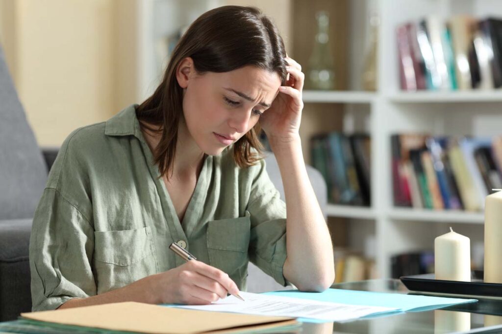 Sad woman ready to sign a contract complaining at home